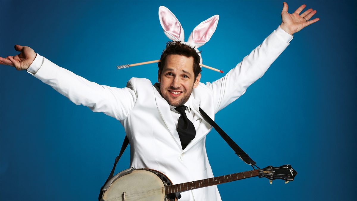 Paul Rudd with a banjo wearing bunny ears.