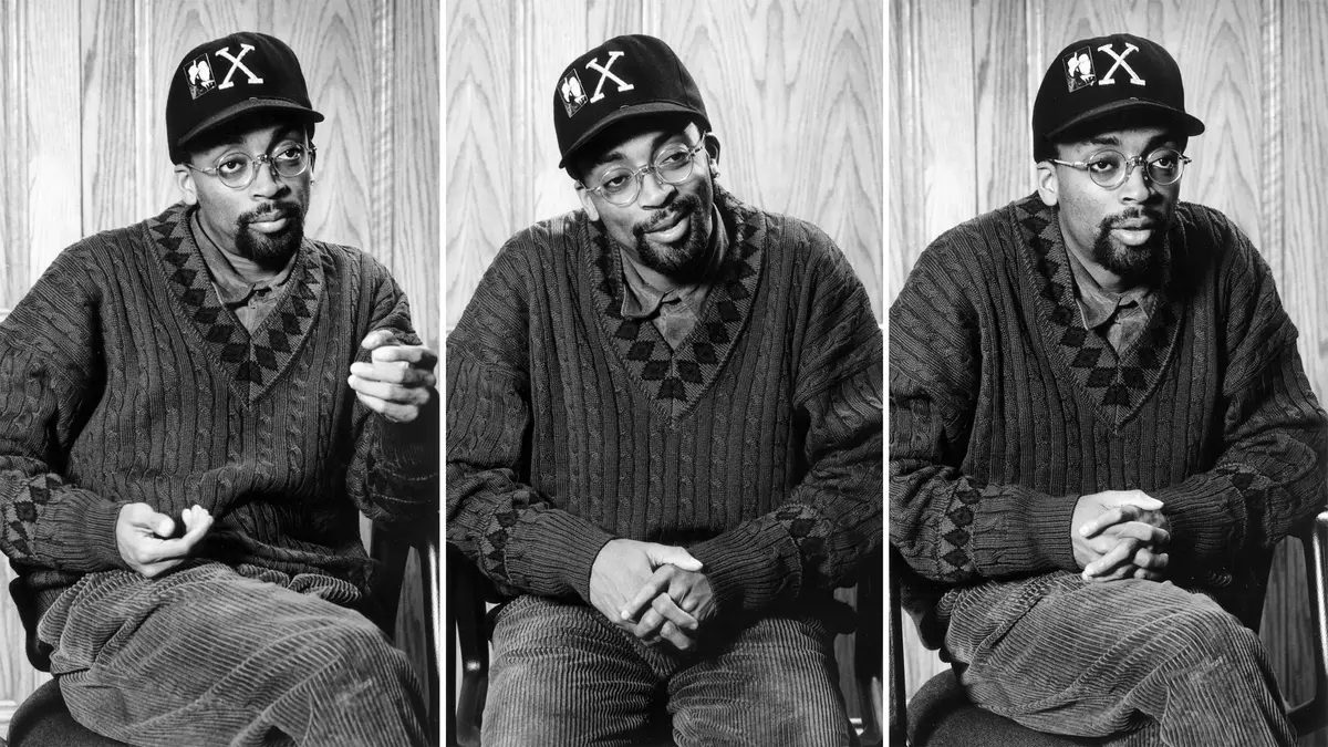 Spike Lee wearing a baseball cap making three different faces.